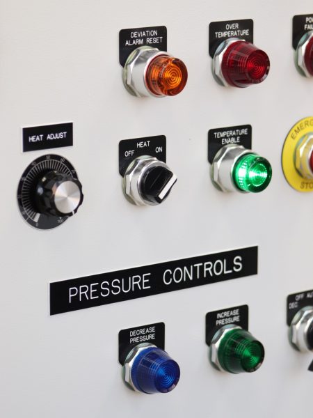 Colorful buttons and knobs to adjust temperature and pressure.